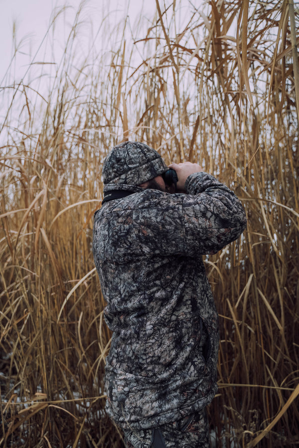 Hunter concealed in tall Real World Giant Miscanthus grass used for food plot screening and deer hunting cover